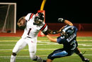 Bolingbrook QB Shadonta Travis stiff arms a Mustang defender.